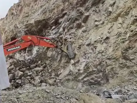 Excavator working the rock face at the mine