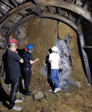 Geologists inspecting the ore face underground